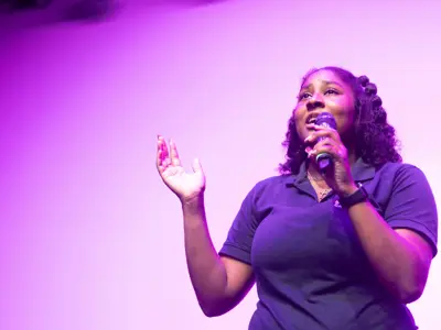 Student singing on stage