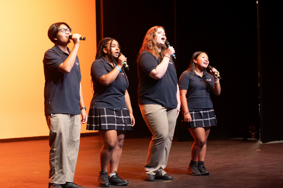 Students singing on stage